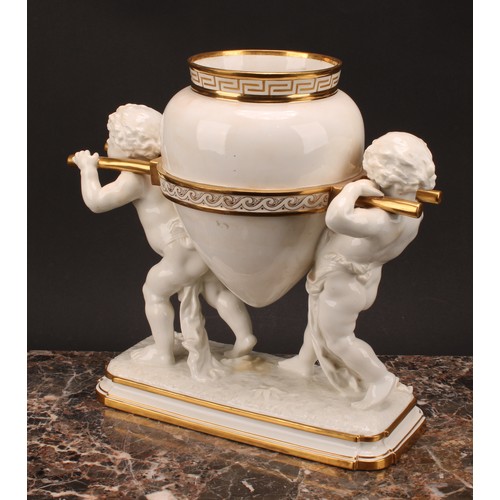 33 - A late 19th century Mintons porcelain figural table centrepiece, modelled as two partially-draped pu... 