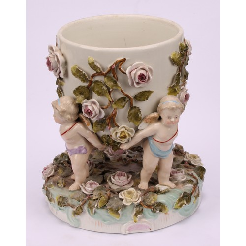 150 - A pair of Sitzendorf porcelain cache pots, each supported by four cherubs, the shaped circular base ... 