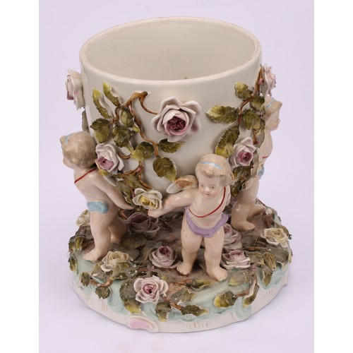 150 - A pair of Sitzendorf porcelain cache pots, each supported by four cherubs, the shaped circular base ... 