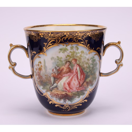 131 - A Continental porcelain trembleuse two-handled chocolate cup and cover, painted with courting couple... 