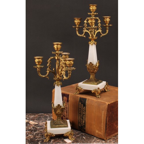 1245 - A pair of Louis XVI style gilt metal mounted three branch four light candelabra, 38cm high