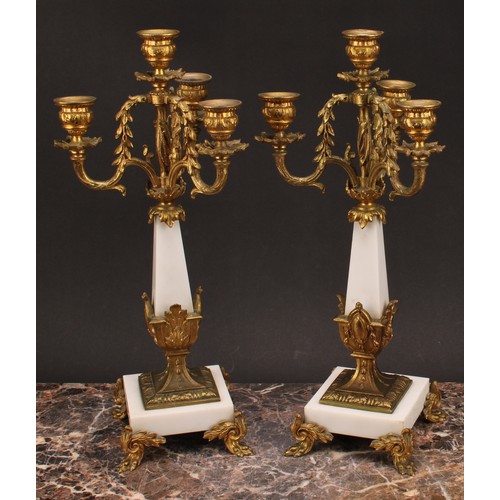 1245 - A pair of Louis XVI style gilt metal mounted three branch four light candelabra, 38cm high