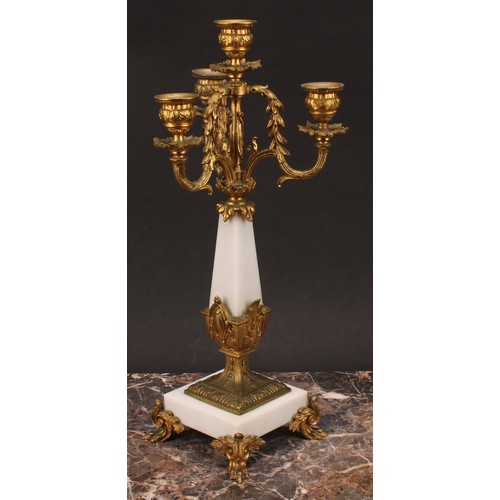 1245 - A pair of Louis XVI style gilt metal mounted three branch four light candelabra, 38cm high