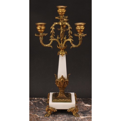 1245 - A pair of Louis XVI style gilt metal mounted three branch four light candelabra, 38cm high