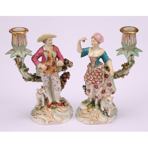 145 - A pair of Continental porcelain figural candlesticks, probably Samson Paris, modelled as a shepherd ... 