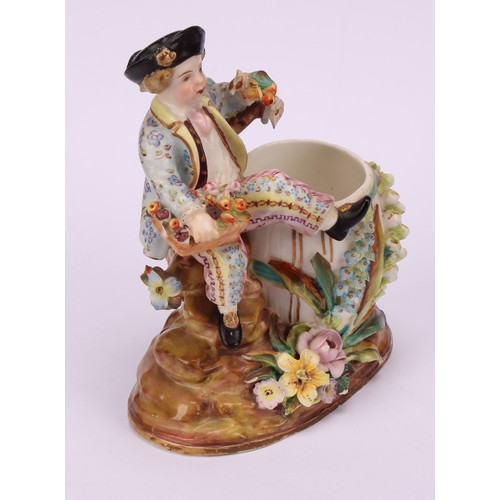 31 - A John Bevington porcelain figural candlestick, allegorical of Winter, as a skater with turquoise ja... 