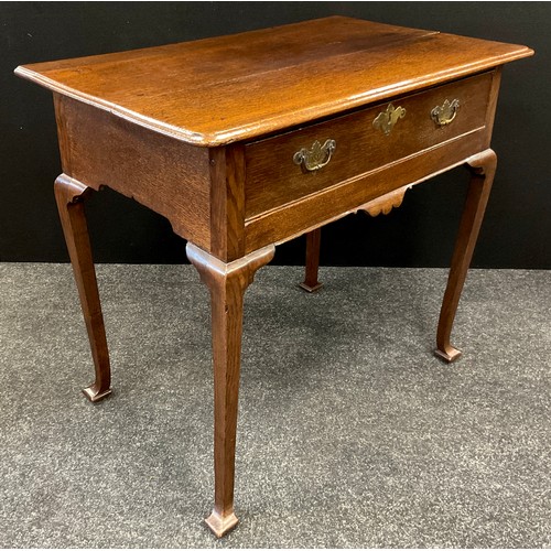 1488 - A 19th century oak lowboy, oversailing rectangular top above a long frieze drawer, tapered square le... 