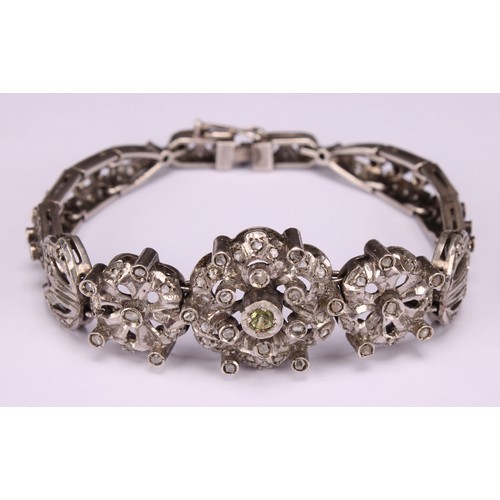 933 - A Belle Époque diamond and white metal bracelet, centered with three graduated flowerheads flanked b... 