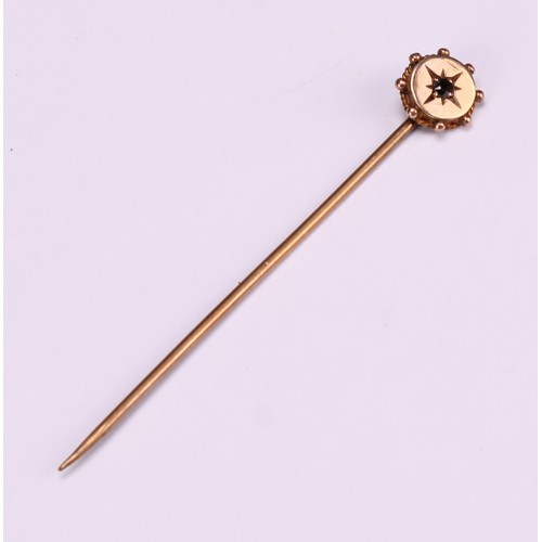 970 - Stick Pins - a 9ct gold flowerhead stick pin, illusion set with a single stone; a 9ct Three Legs of ... 