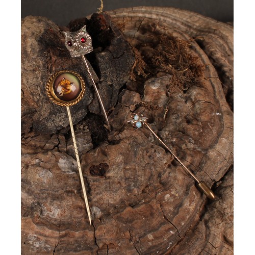 980 - Stick Pins - An Essex rock crystal reverse intaglio stick pin, decorated with a fox mask, rope twist... 