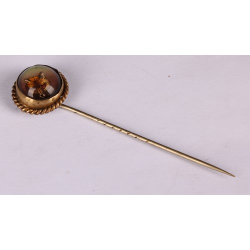 980 - Stick Pins - An Essex rock crystal reverse intaglio stick pin, decorated with a fox mask, rope twist... 