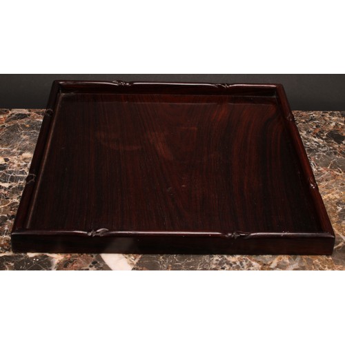 245 - A Chinese hardwood gallery tray, carved with a border of leafy bamboo, 33cm wide, c.1900