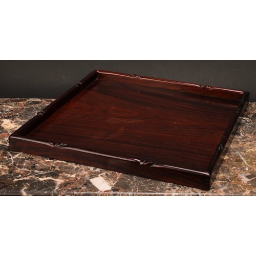 245 - A Chinese hardwood gallery tray, carved with a border of leafy bamboo, 33cm wide, c.1900