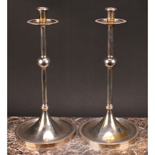 576 - Interior Design - a pair of large E.P.N.S candlesticks, of Christopher Dresser influence, broad drip... 