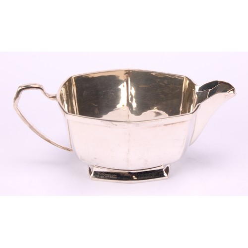 673 - A George VI silver three piece tea service, comprising teapot, cream jug and sugar basin, Charles S ... 