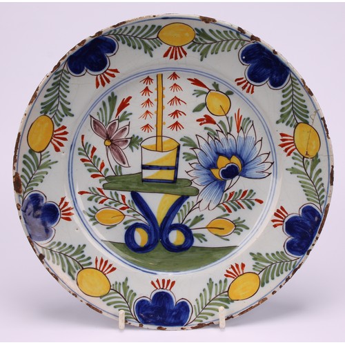 12 - A pair of 18th century Dutch Delft plates, painted in polychrome, with flowers and table, 22cm diame... 