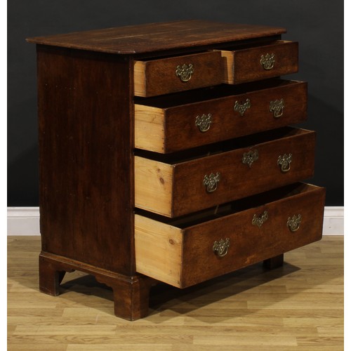 1192 - A George III oak chest, rectangular top with canted foreangles, above two short and three long gradu... 