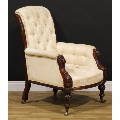 1353 - A Victorian mahogany library chair, stuffed-over deep-button upholstery, the hand rests carved as li... 