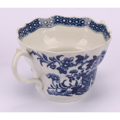 78 - A Worcester Fence pattern ogee shaped chocolate cup and saucer, in underglaze blue, cell border, ser... 