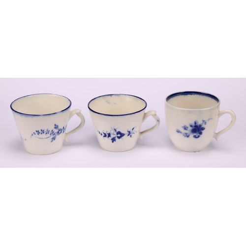 29 - A Caughley Chantilly Sprig pattern coffee cup, in underglaze blue, kick handle, 6cm high; a Caughley... 