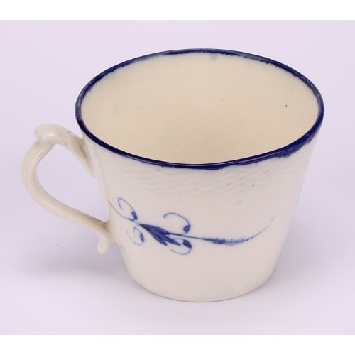 29 - A Caughley Chantilly Sprig pattern coffee cup, in underglaze blue, kick handle, 6cm high; a Caughley... 