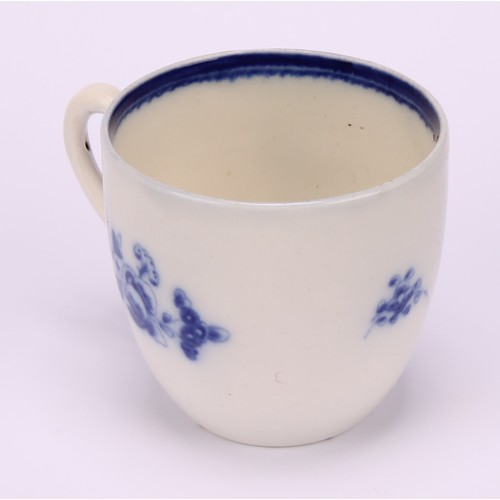 29 - A Caughley Chantilly Sprig pattern coffee cup, in underglaze blue, kick handle, 6cm high; a Caughley... 