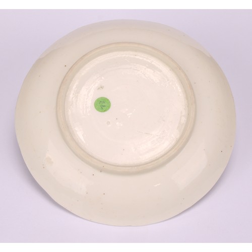 45 - A Bow blanc de chine shaped circular saucer, typically applied with blossoming prunus, 11cm diameter... 