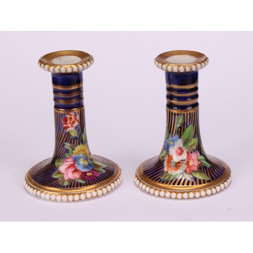 39 - A pair of Spode flared miniature candlesticks, finely painted in coloured enamels with flowers and l... 