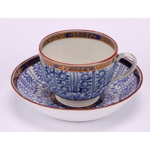 86 - A Worcester Royal Lily pattern cup and saucer, in underglaze blue, gilt highlighted borders, red lin... 