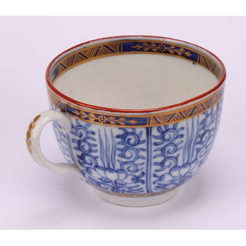 86 - A Worcester Royal Lily pattern cup and saucer, in underglaze blue, gilt highlighted borders, red lin... 