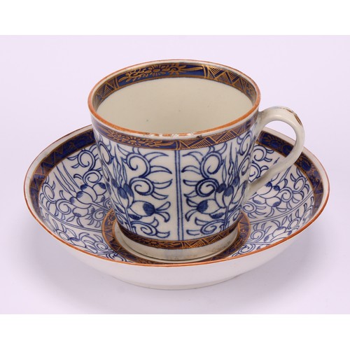 86 - A Worcester Royal Lily pattern cup and saucer, in underglaze blue, gilt highlighted borders, red lin... 