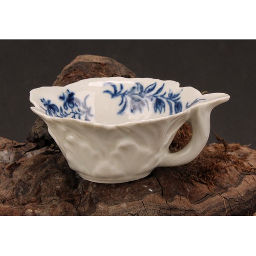 79 - A Worcester geranium moulded butter boat, decorated in underglaze blue with the Formal Rose pattern,... 