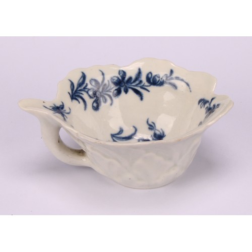 79 - A Worcester geranium moulded butter boat, decorated in underglaze blue with the Formal Rose pattern,... 