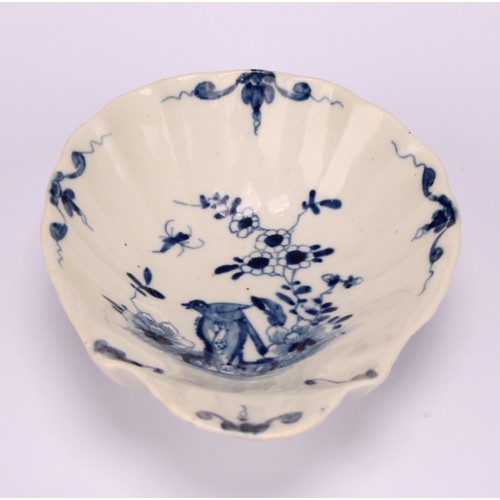 93 - A Worcester Two Peony Rock Bird pattern shell shaped dish, painted with a bird perched on a tall pie... 