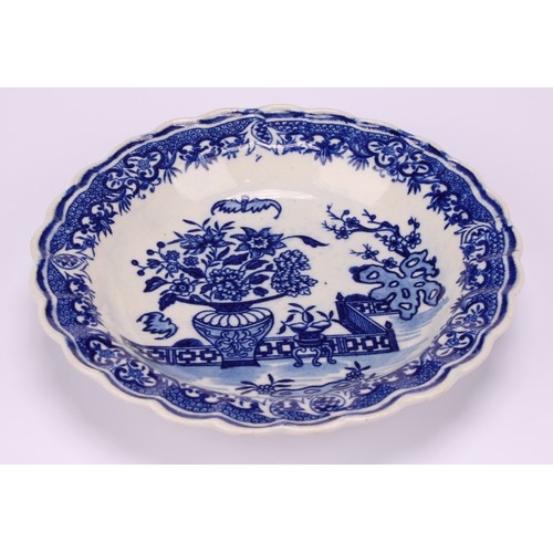 76 - A Worcester Bat pattern scalloped napkin dish, decorated in underglaze blue with a chinoiserie garde... 