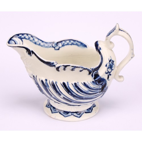 100 - A Derby cream boat, in relief with flutes, the spout with entwined dolphins, scroll handle, feather ... 