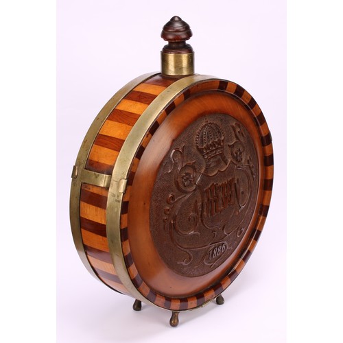 1184 - A 19th century Continental fruitwood circular flask, banded borders, carved in relief with a crowned... 