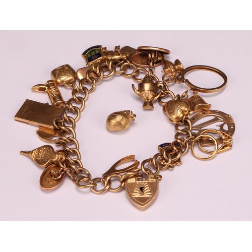 930 - A 9ct gold charm bracelet, the links and love heart clasp stamped '375' and '9ct', assorted 9ct gold... 