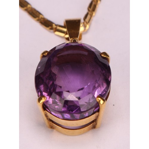 959 - An Amethyst pendant necklace, the oval amethyst approximately 17mm x 13mm, indistinctly marked yello... 