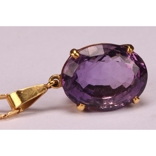 959 - An Amethyst pendant necklace, the oval amethyst approximately 17mm x 13mm, indistinctly marked yello... 