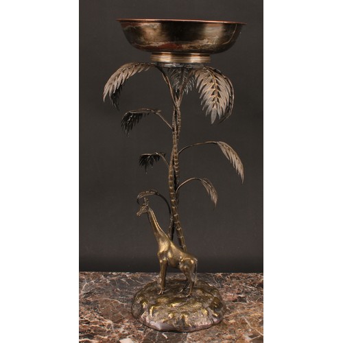 548 - A late 19th century E.P.N.S. table centrepiece, modelled with a giraffe standing beneath palm trees,... 