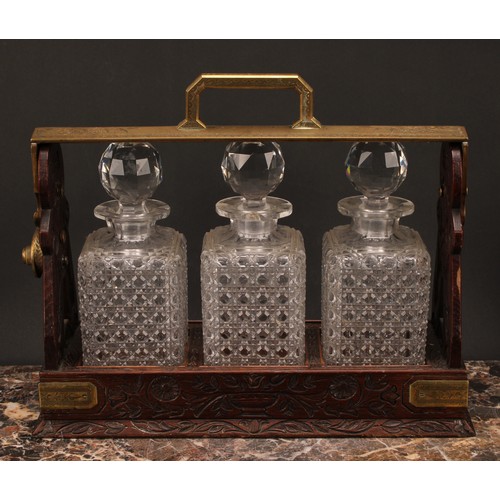 1899 - A Victorian oak three bottle tantalus, Betjemann's Patent London, 'The Tantalus', the mobile brass c... 