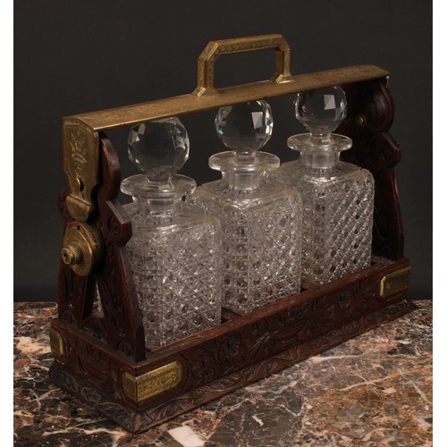 1899 - A Victorian oak three bottle tantalus, Betjemann's Patent London, 'The Tantalus', the mobile brass c... 