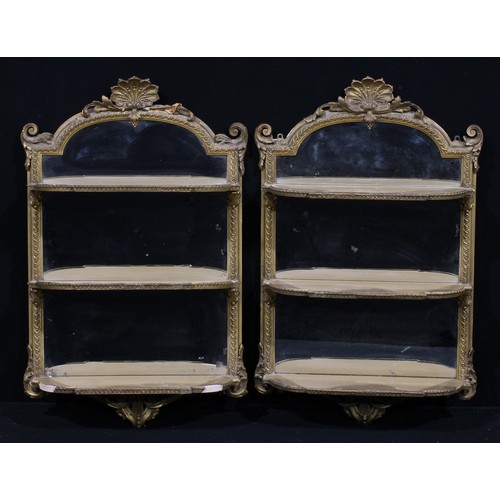 1277 - A pair of Louis XV Revival giltwood and gesso salon wall shelves, each with shell cresting above thr... 