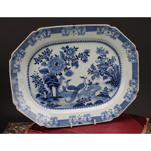 216 - A Chinese export canted rectangular meat plate, painted in tones of underglaze blue with a pair of s... 