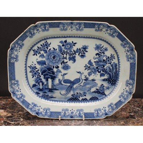 216 - A Chinese export canted rectangular meat plate, painted in tones of underglaze blue with a pair of s... 