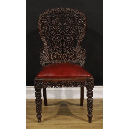 1320 - A 19th century Burmese hardwood side chair, pierced and profusely carved with scrolls, 87cm high, 47... 