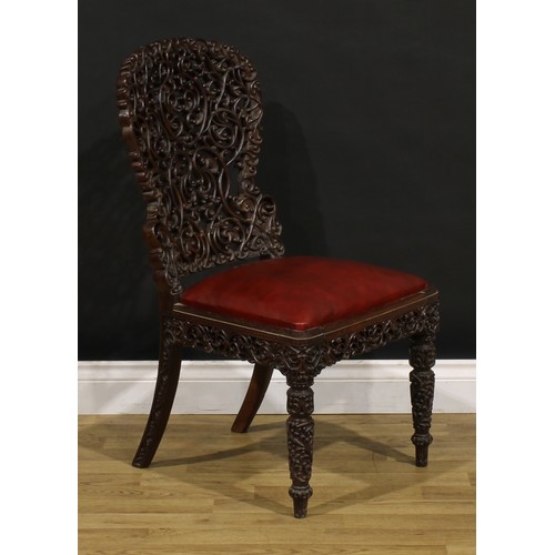 1320 - A 19th century Burmese hardwood side chair, pierced and profusely carved with scrolls, 87cm high, 47... 