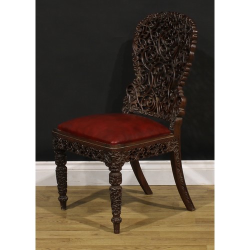 1320 - A 19th century Burmese hardwood side chair, pierced and profusely carved with scrolls, 87cm high, 47... 