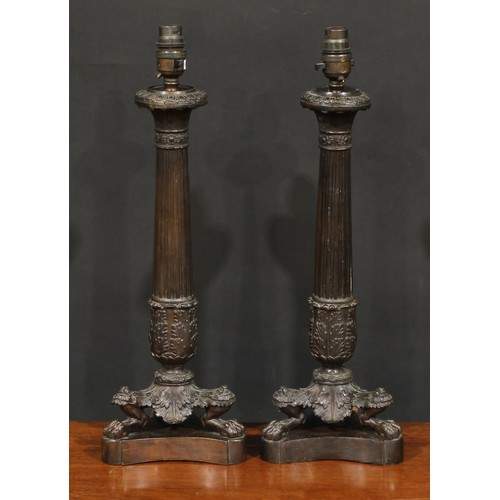 1248 - A pair of modern Empire style patinated bronze lamps, fluted columns terminating in a spreading acan... 